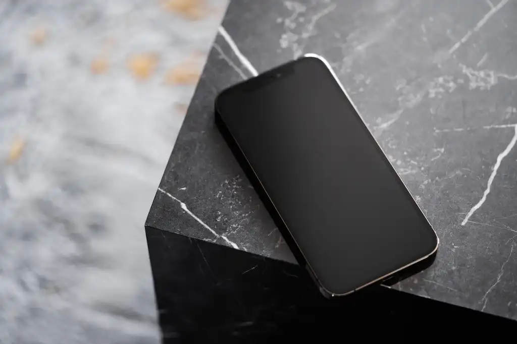 smartphone on black marble table free photo