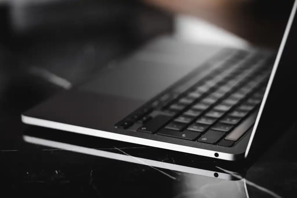 laptop keyboard close up on a glossy table free photo