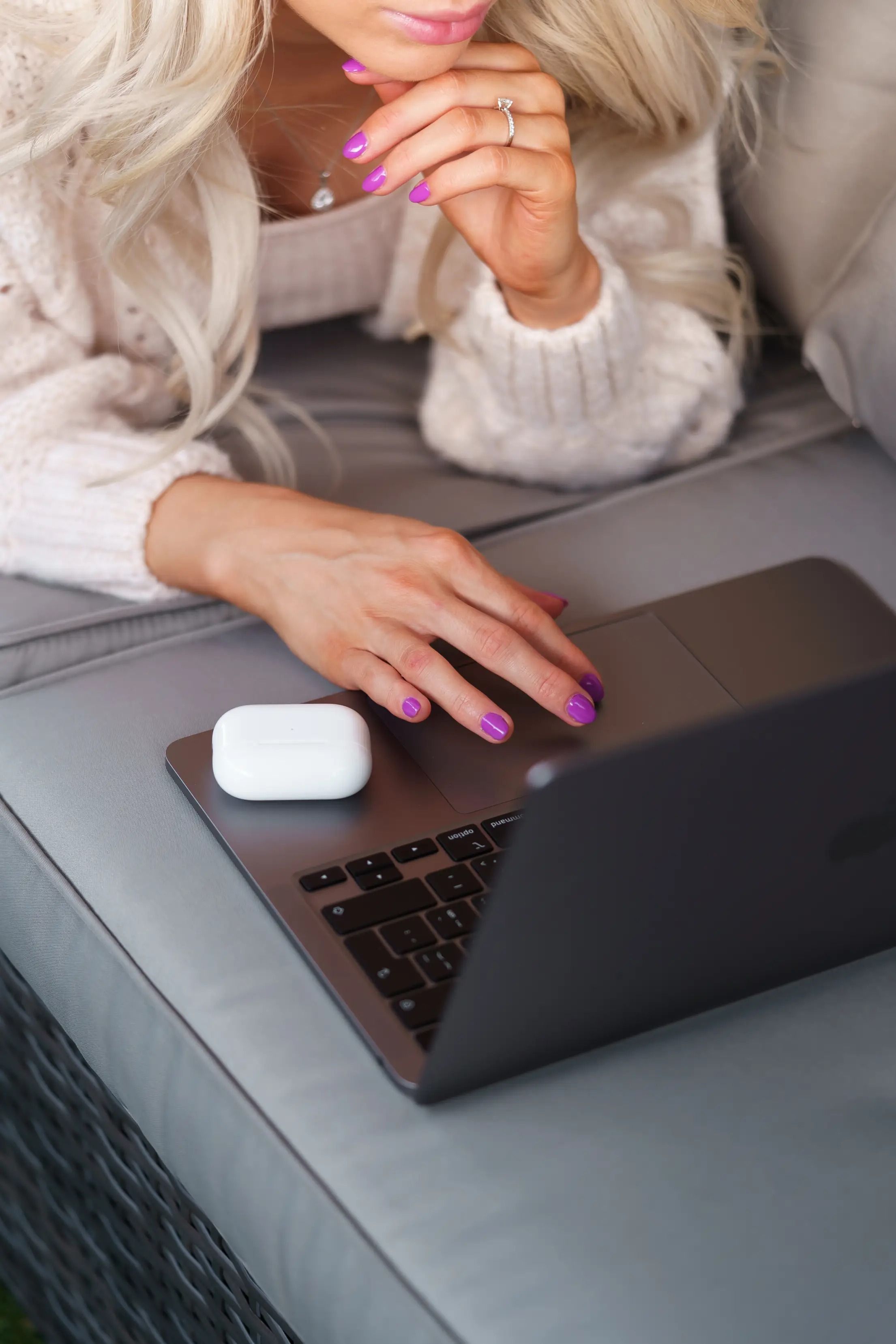 young woman using her laptop on a garden seat free photo